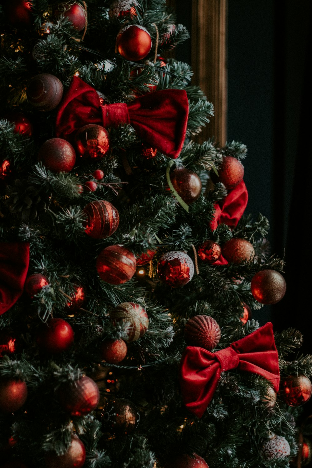 green and red christmas tree with baubles