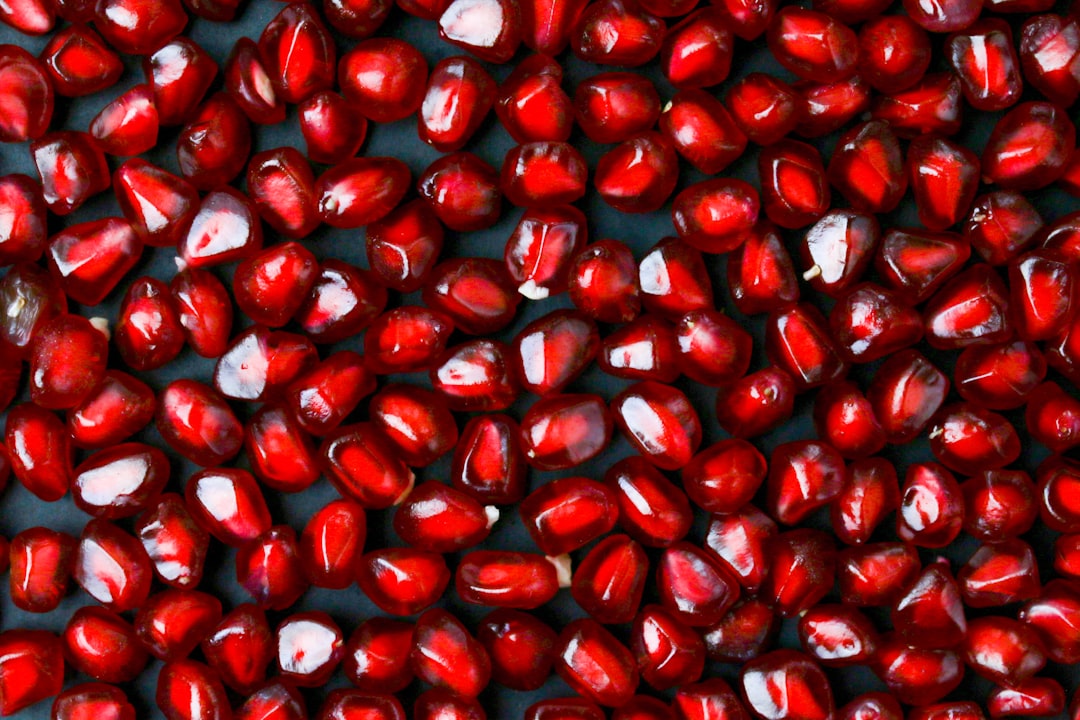 red round fruits on white textile
