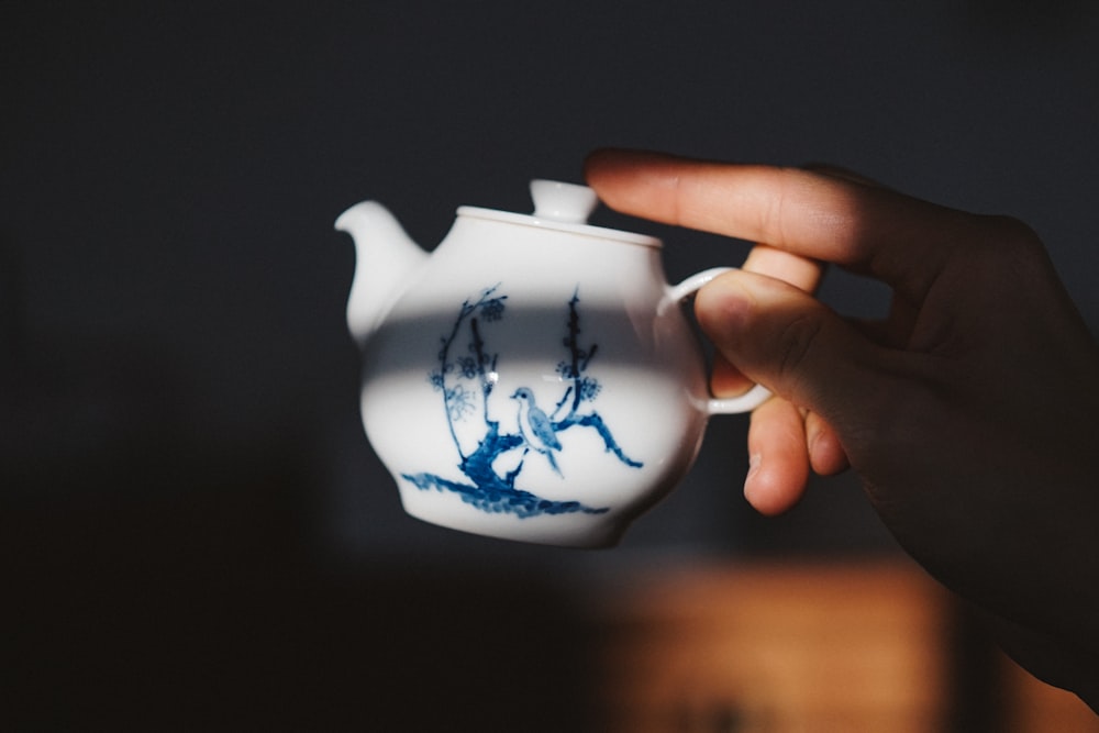 white and blue floral ceramic teapot