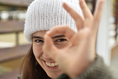 smiling woman wearing white knit cap
