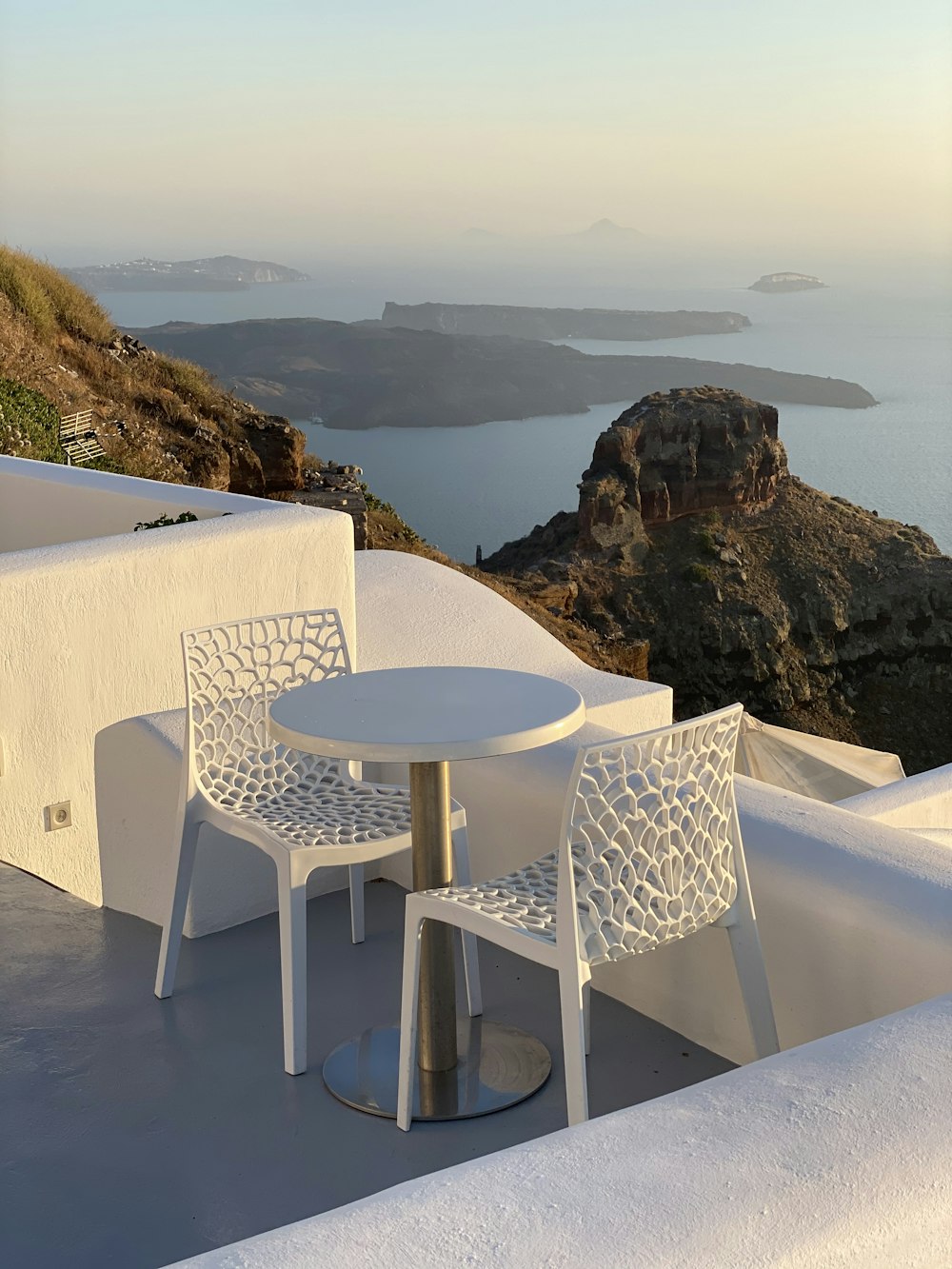 white table and chairs on top of the hill