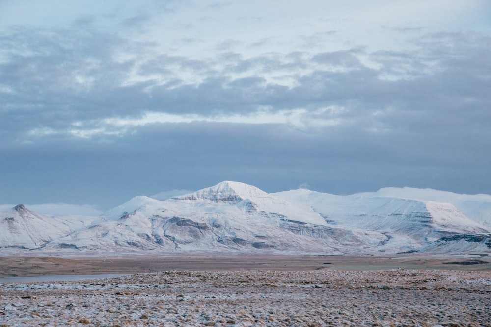 snow covered mountains under cloudy sky during daytime