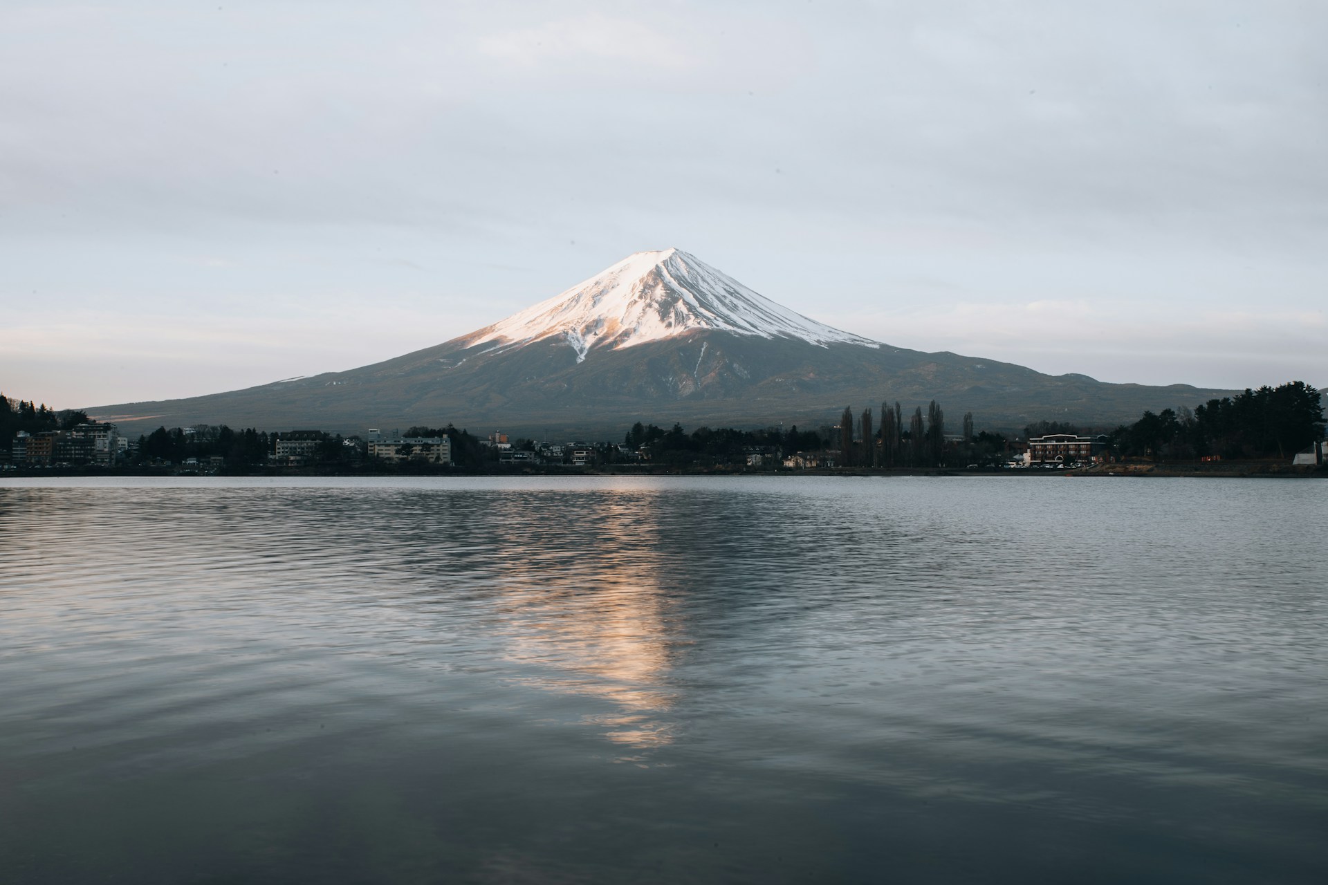 white and black mountain near body of water during daytime