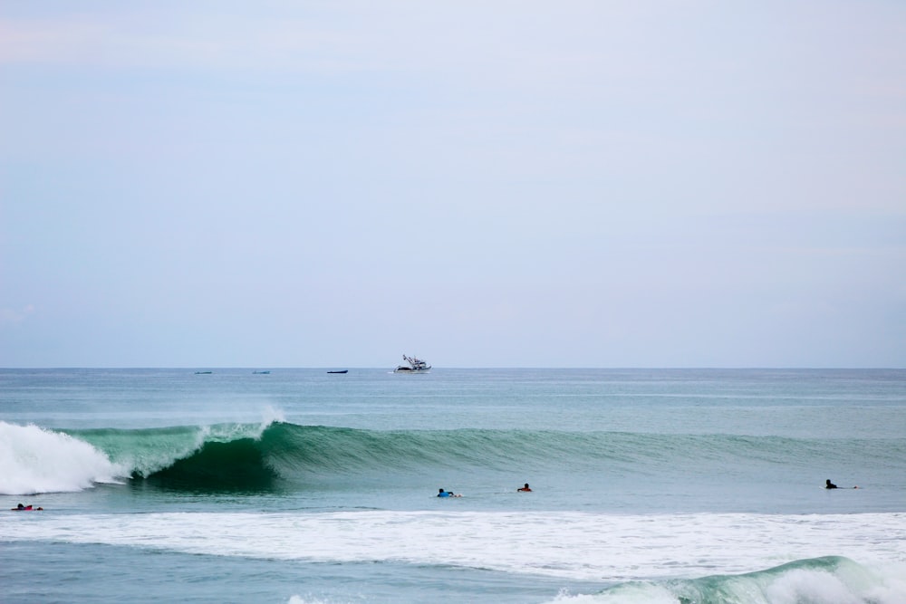 person surfing on sea waves during daytime