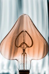 gold cross pendant on white textile