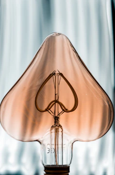 gold cross pendant on white textile