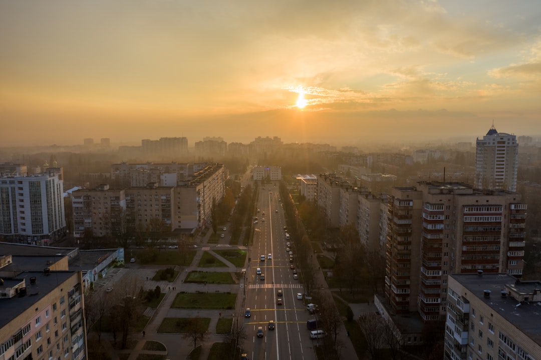 city buildings during sunset with white clouds