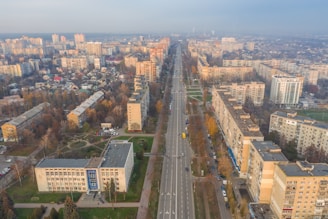 An aerial view of a city with electric vehicles on the road.