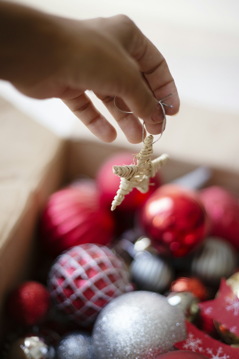 gold and red baubles on persons hand