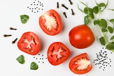red tomato on white surface