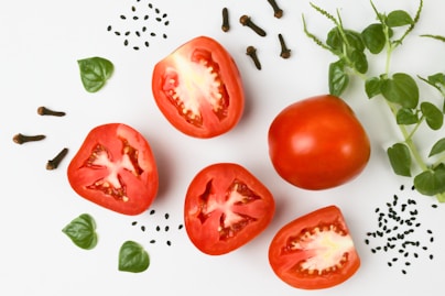 red tomato on white surface