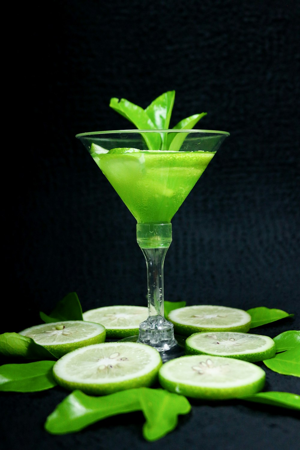 clear cocktail glass with sliced lime