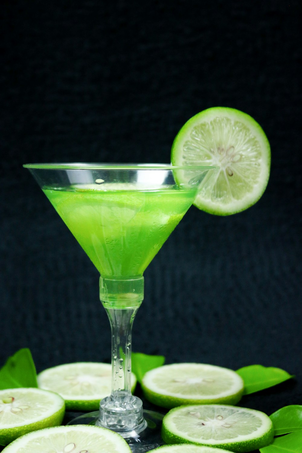 clear cocktail glass with sliced lime