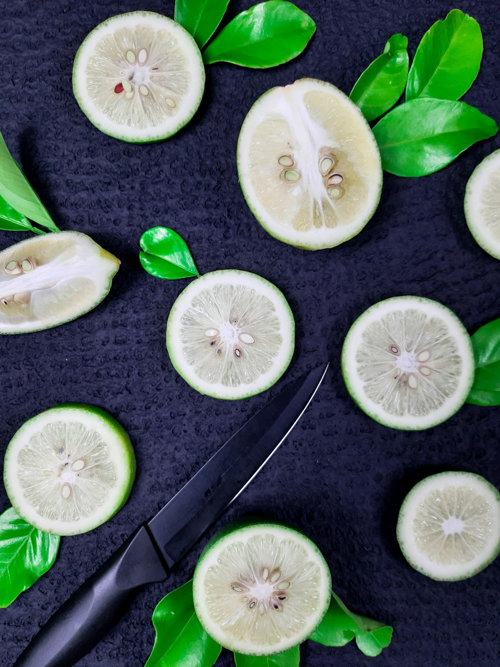 sliced lime on black wooden table