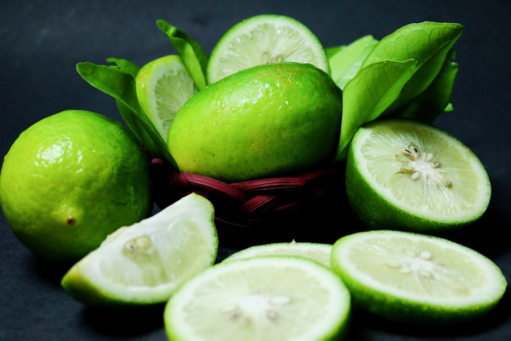 sliced green fruit on red plastic basket