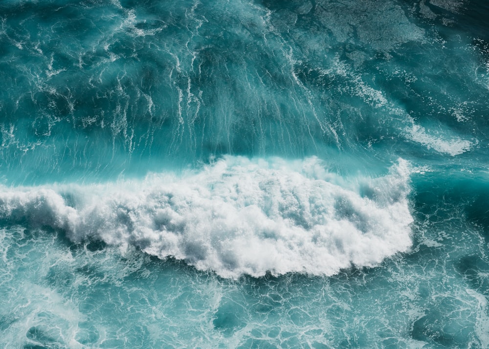 ocean waves crashing on shore during daytime