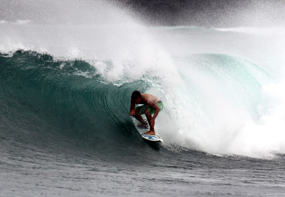 man surfing on sea waves during daytime