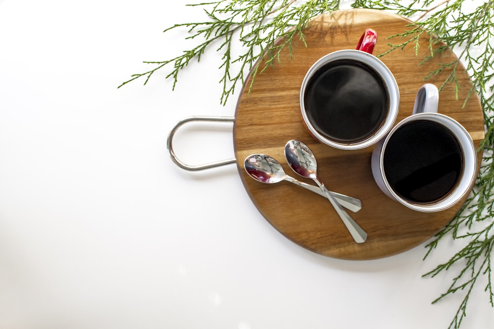 black liquid in white ceramic mug on brown wooden round tray