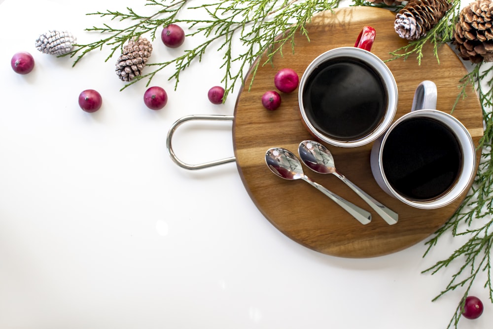 black liquid in white ceramic mug on brown wooden round tray