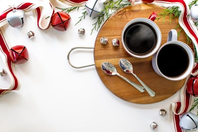 stainless steel fork and knife on brown wooden round plate sleigh bells zoom background