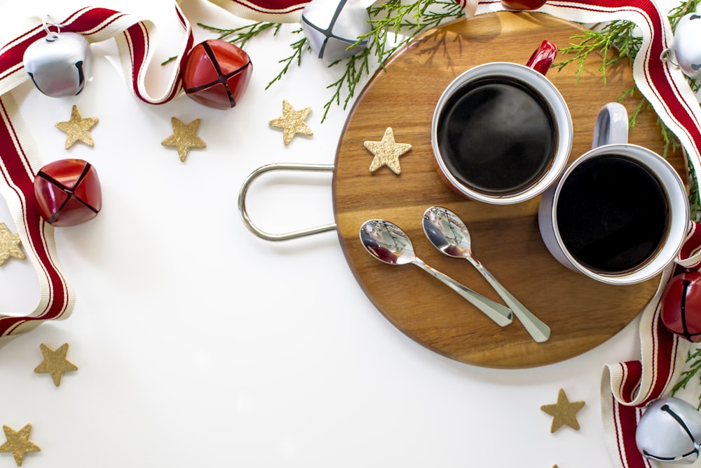 stainless steel fork beside white ceramic mug on brown wooden round plate