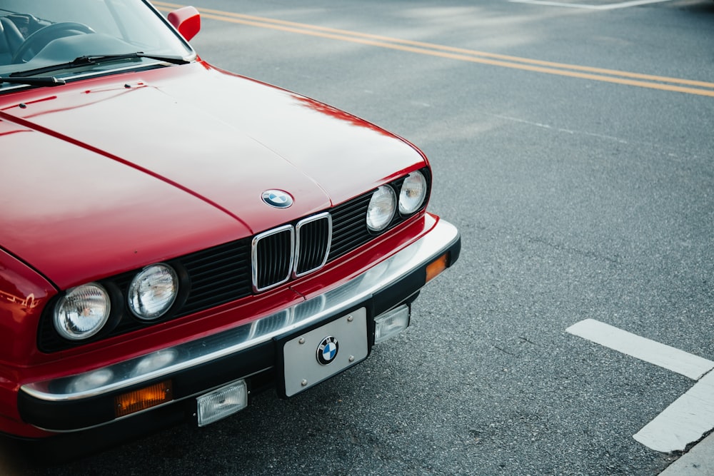 red bmw car on road during daytime