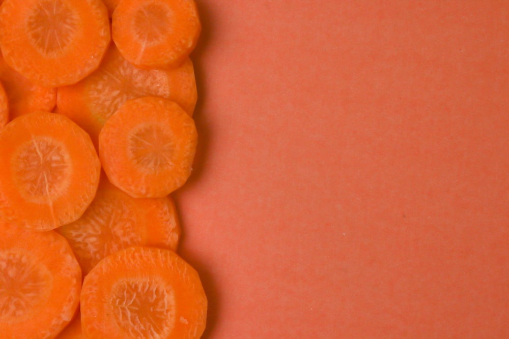 sliced orange fruit on brown surface