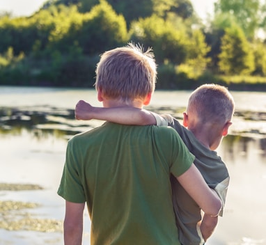 boy in green t-shirt standing beside boy in green t-shirt