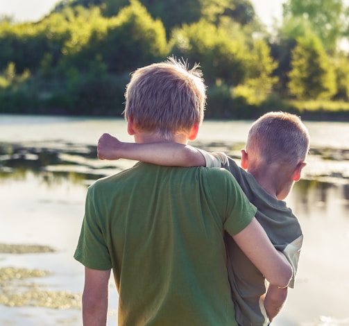 boy in green t-shirt standing beside boy in green t-shirt