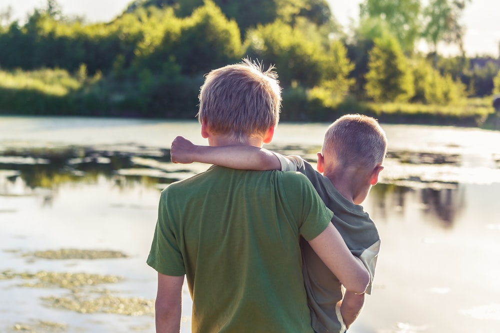 boy in green t-shirt standing beside boy in green t-shirt