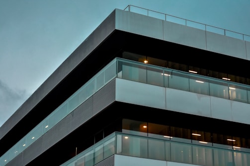 Modern residential building facade with clean lines and large windows under soft natural light.