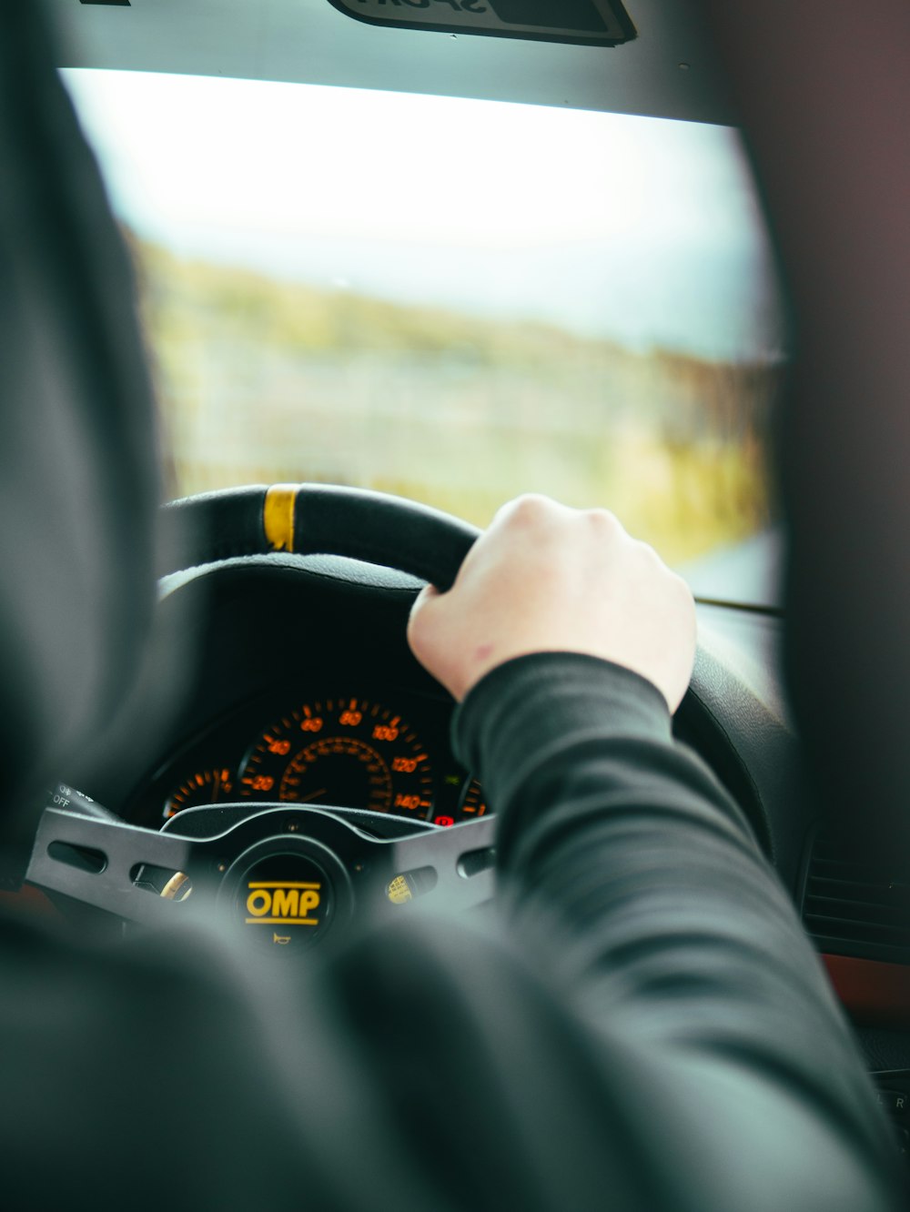 person holding black steering wheel