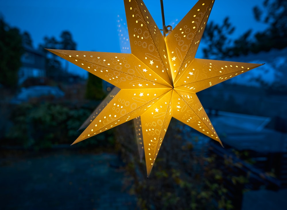 yellow star ornament on blue body of water during daytime