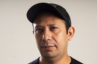 A black background with a cap photo upload interface.