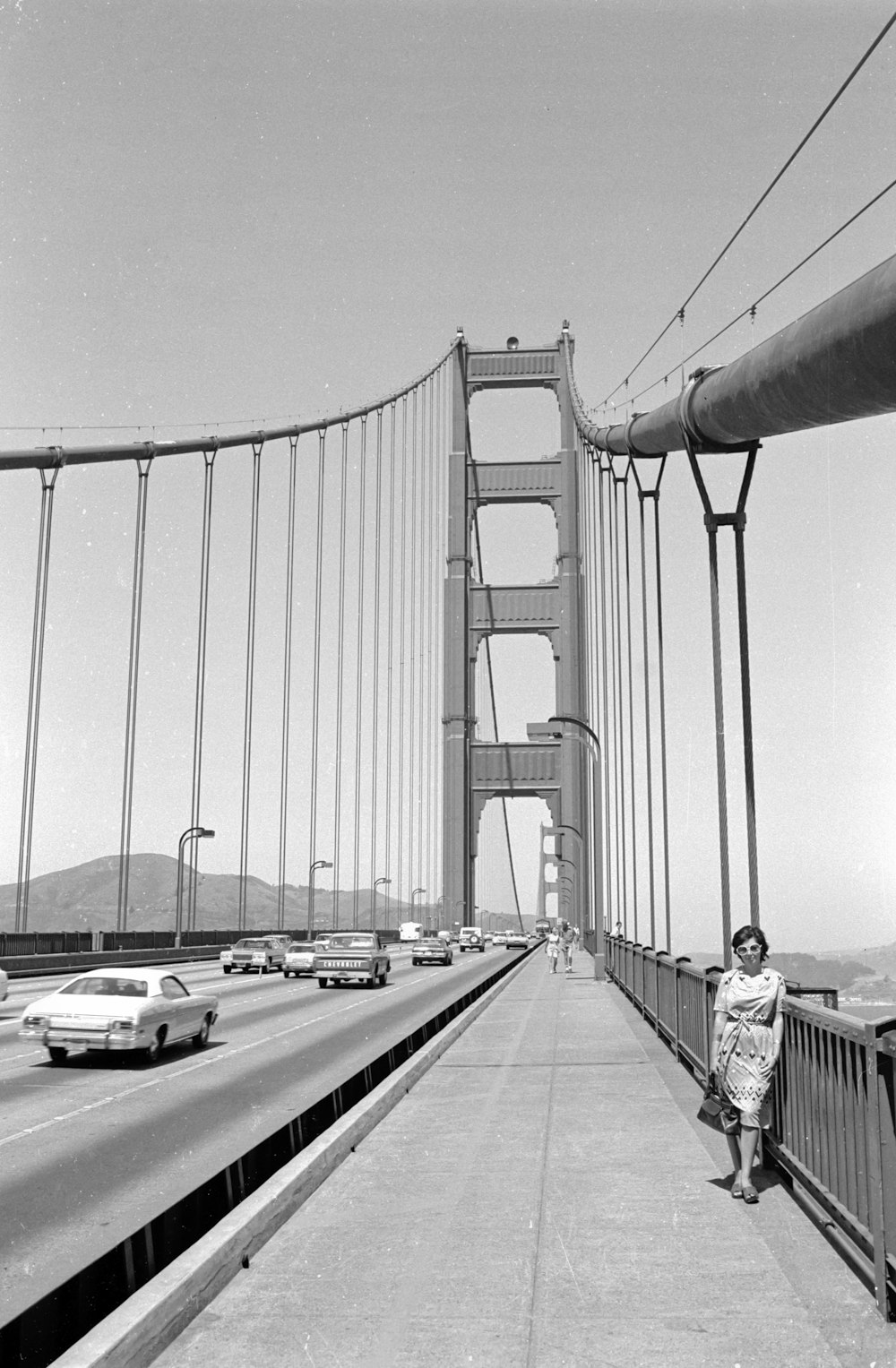 grayscale photo of bridge with cars on road