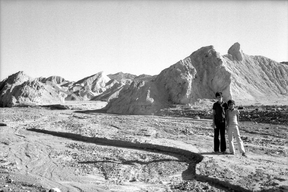 man and woman standing on snow covered ground