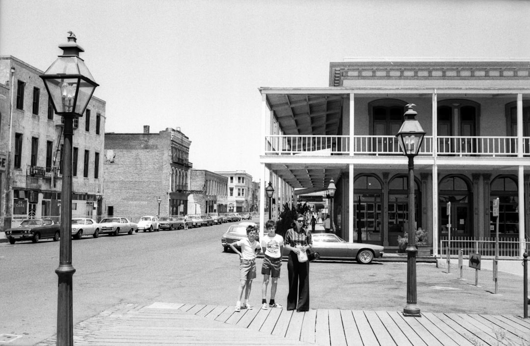 grayscale photo of people walking on sidewalk near building, Sacramento 1973
