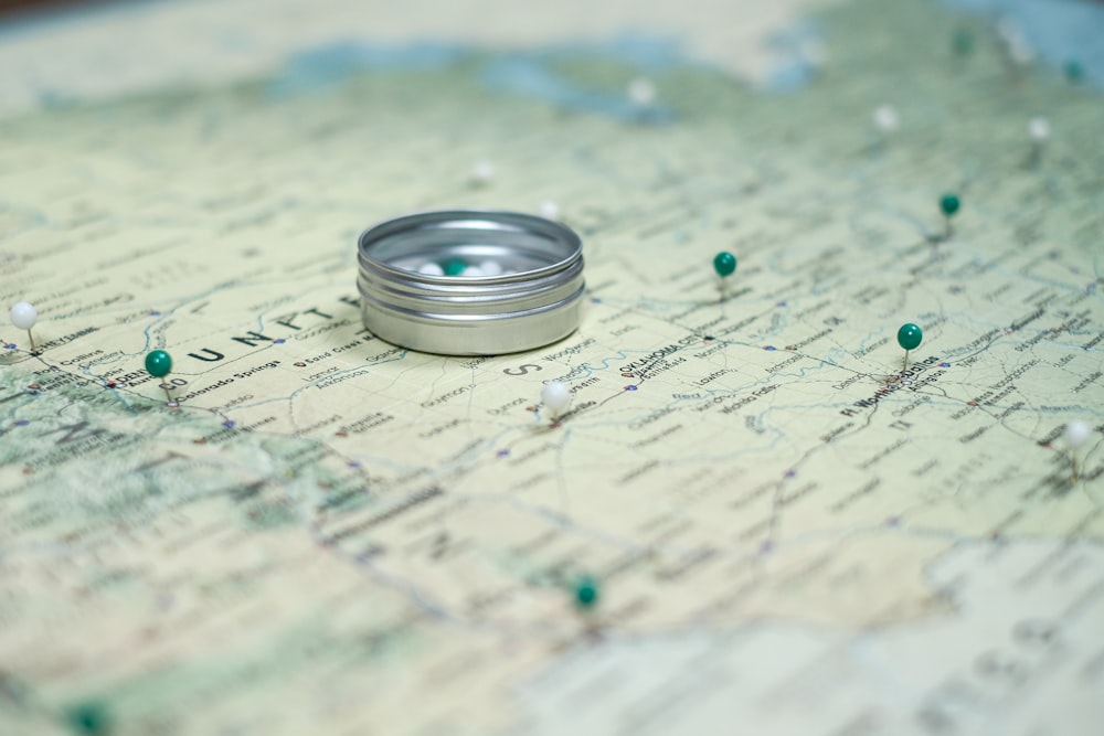 silver ring on white and blue textile