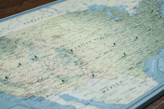 white and blue map on brown wooden table