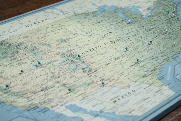 white and blue map on brown wooden table