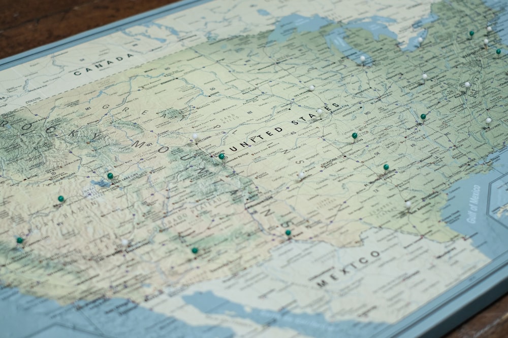 white and blue map on brown wooden table