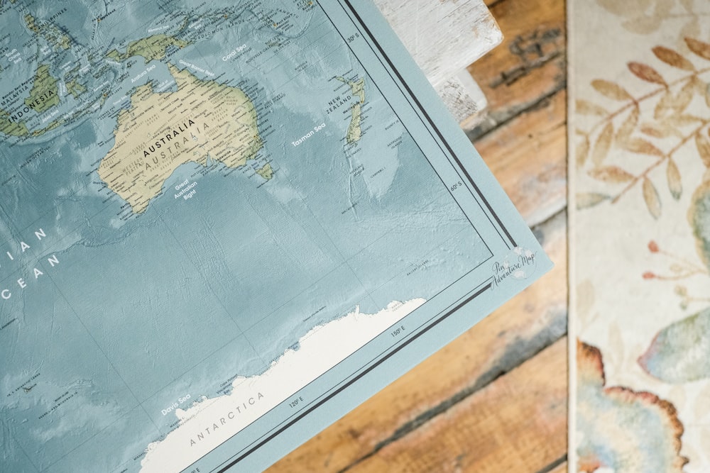 blue and white map on brown wooden table