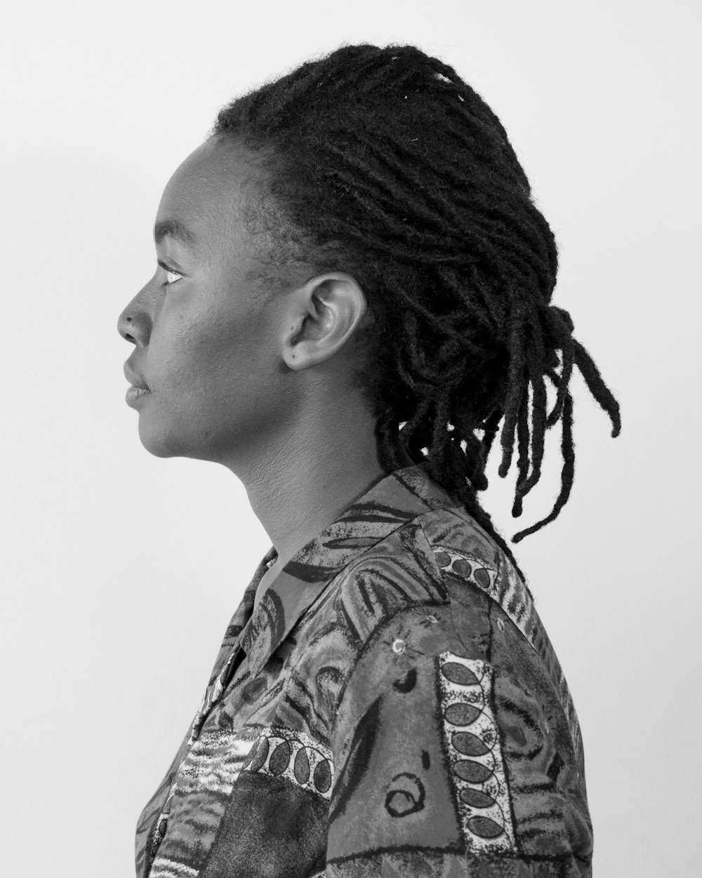 grayscale photo of woman in floral shirt