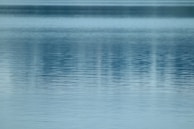 A tranquil water feature reflecting soft blue hues indoors.