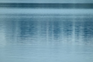 A tranquil water feature reflecting soft blue hues indoors.