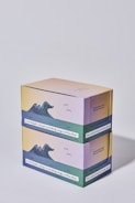 Two stacked pastel-colored boxes featuring an illustration of ocean waves. The boxes have text, including motivational phrases about mindfulness and productivity.
