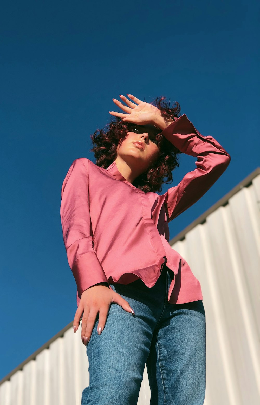 woman in red long sleeve shirt and blue denim jeans