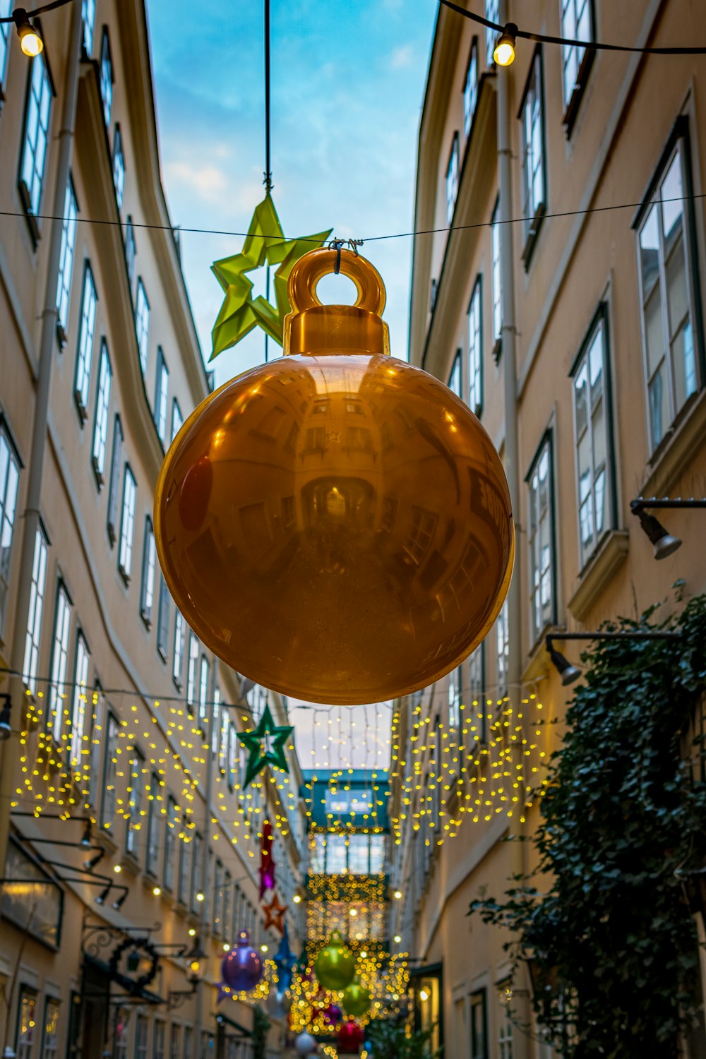 gold bauble on white metal fence