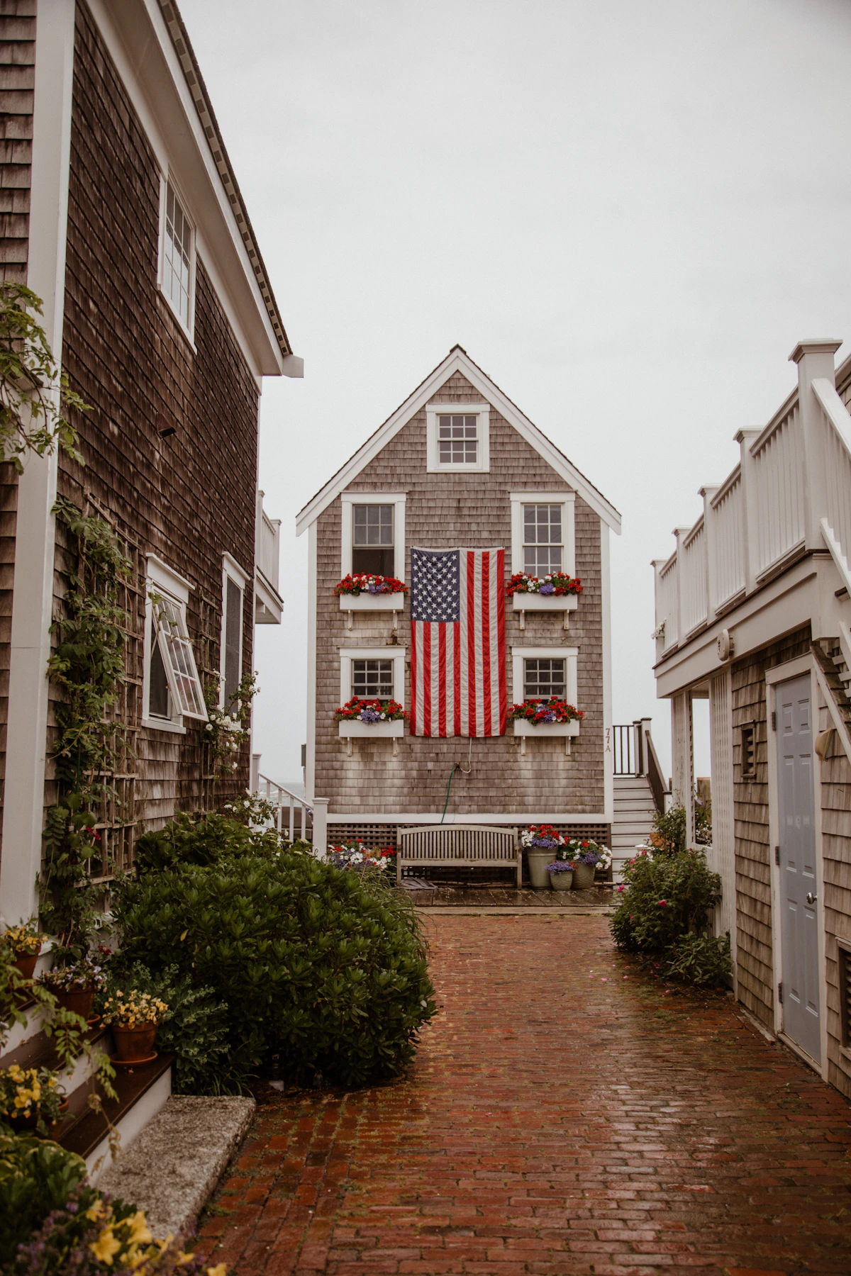 A home with an American flag displayed between its windows
