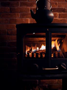 A sleek, modern stove design glowing warmly in a cozy kitchen setting.